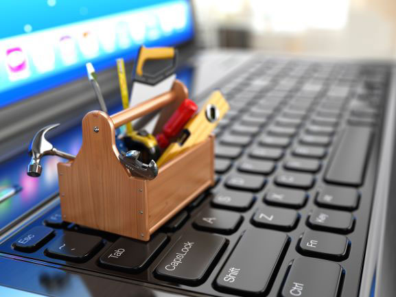 a toolbox sitting on a laptop keypad.