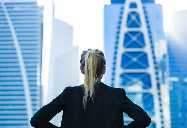 girl with hands on her hips looking out at a new city.