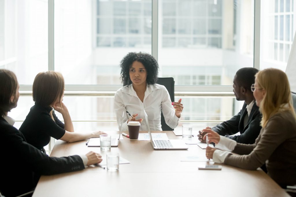 diverse-group-sitting-at-meeting-table-1024x683