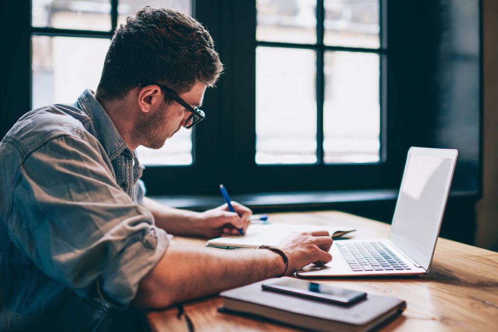 person-using-a-laptop-and-writing-content-
