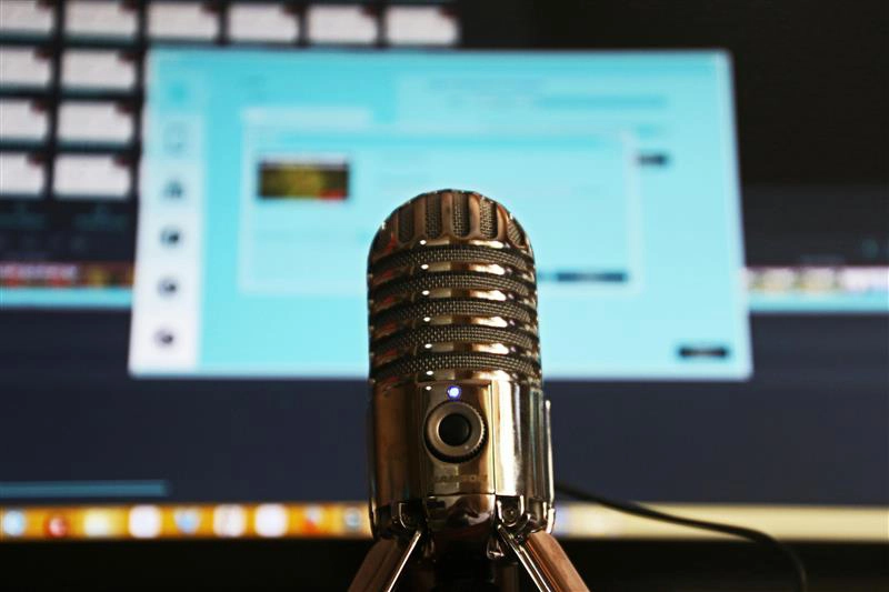 a podcast microphone from the perspective of someone podcasting