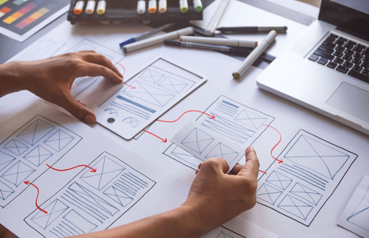 a person drawing wireframes for use experience.